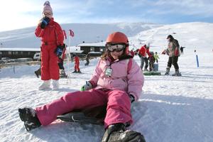Kids tobogganing at Roundhill ski field